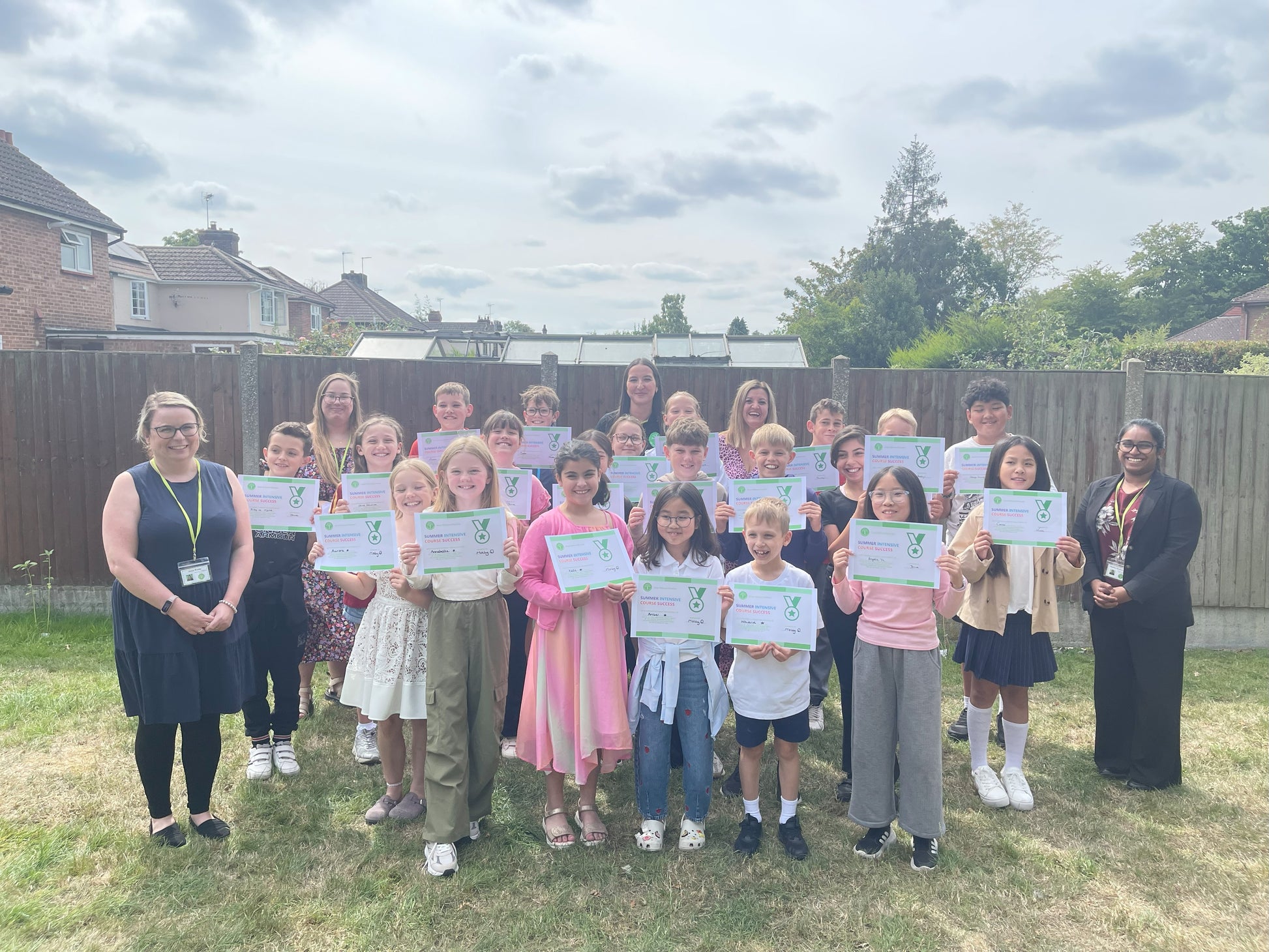 Group of children holding certificates in a residential area